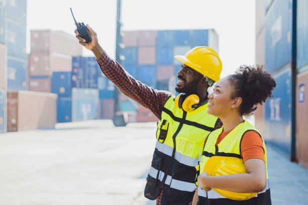 African worker people teamwork happy working together in port cargo shipping industry loading container yard stock photo
