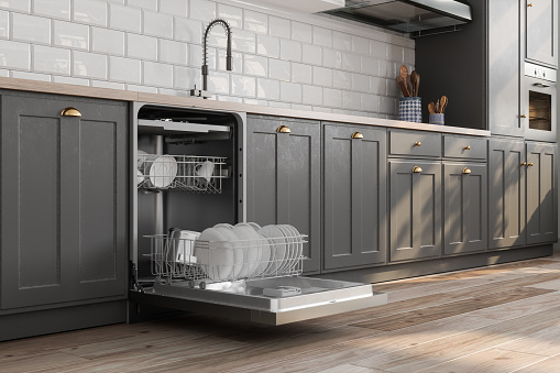 Close-up View Of Open Dishwasher With Kitchen Utensils In It