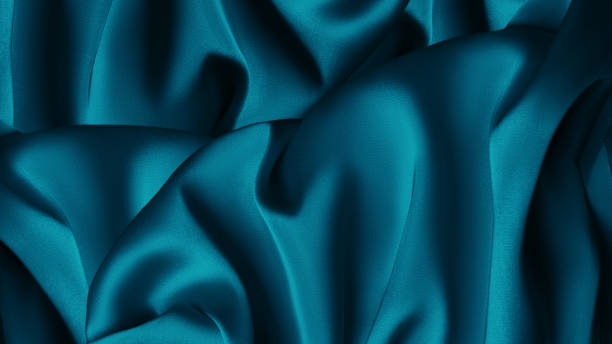istock Blue green silk satin fabric. Teal color elegant background. Liquid wave or silk wavy folds. Beautiful dark turquoise background, Background image of crumpled fabric. Blue silk 1458713733