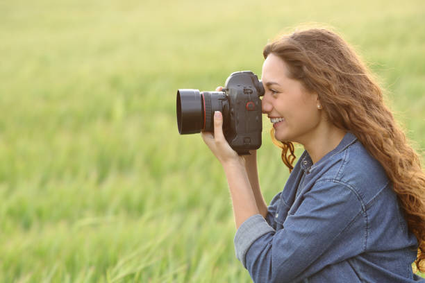 istock Woman taking photos in a field 1458714881