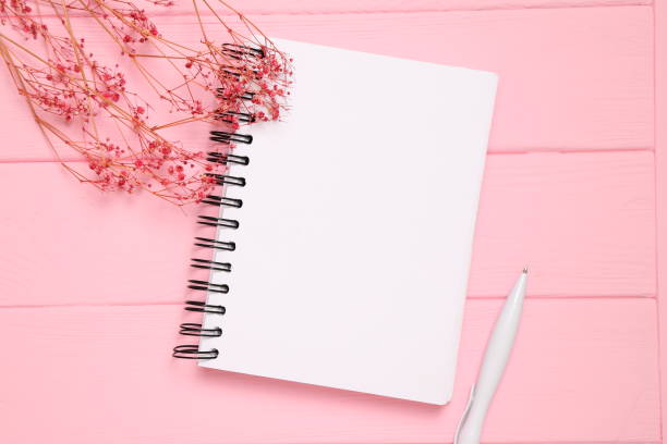 istock Blank notebook sheet, open page, on wooden background 1458715601