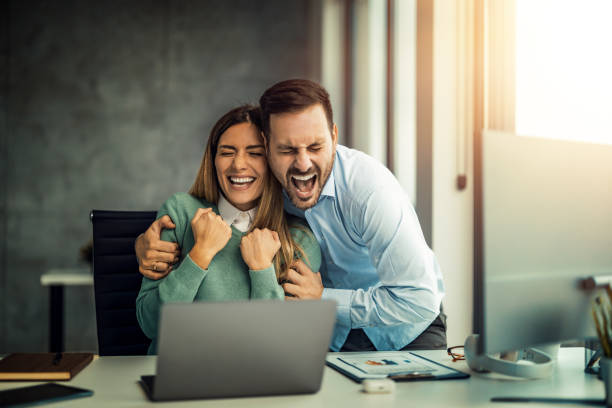 istock Successful business group celebrating in their office 1458715729