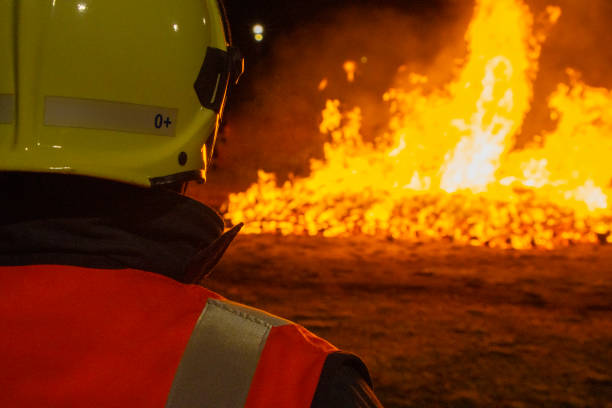 istock Firefighter putting out a fire. Destruction and disaster 1458716661