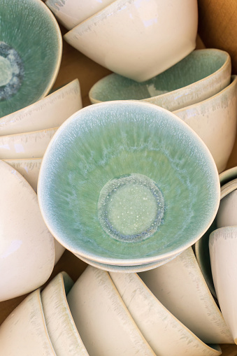 Handmade green ceramic plate stacks background