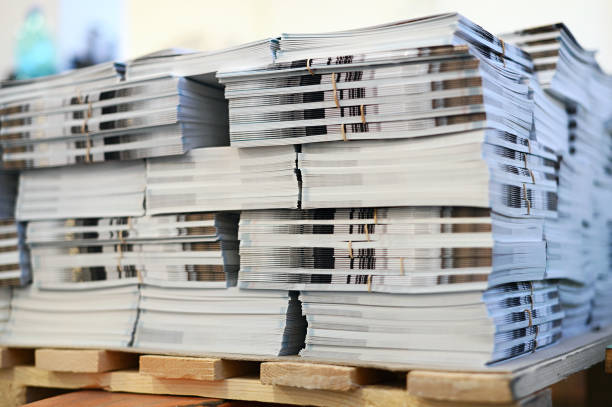 istock Stack of magazines placed on wooden pallet in printing office 1458719246