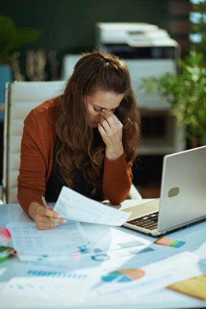 istock business owner woman in green office working with documents 1458719372