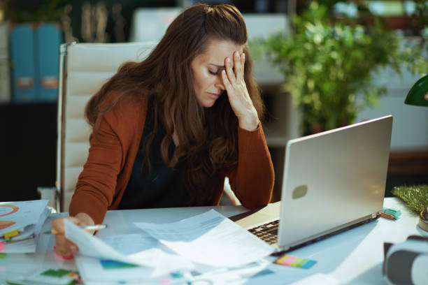 istock business owner woman in green office working with documents 1458719383