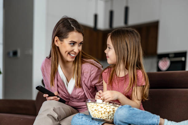 istock Family watching tv at home 1458719432