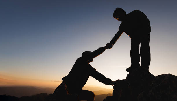 istock People helping each other concept.People helping and, team work concept. Lending a helping hand. 1458720490