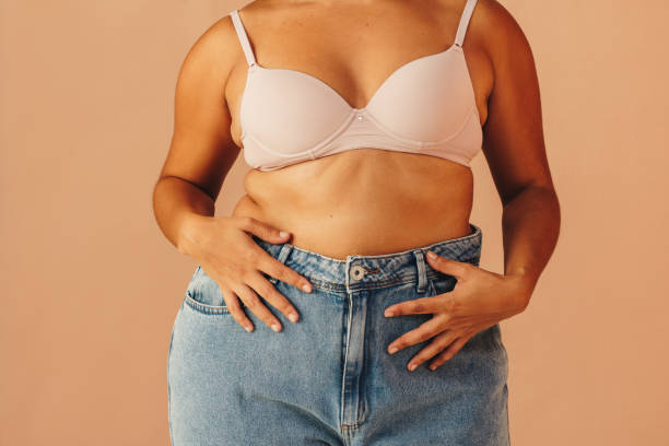 istock Unrecognizable curvy woman wearing a bra and jeans 1458720803
