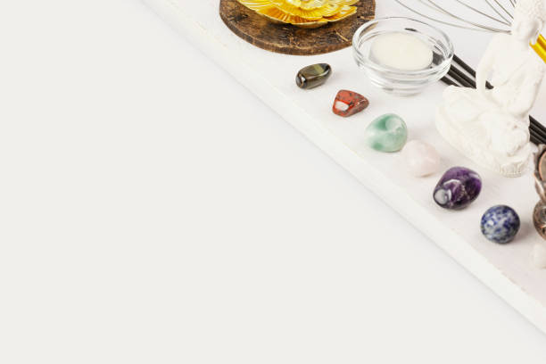 istock buddha figurine, chakra stones, candle and aroma sticks on a white background 1458722210