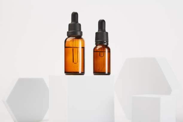 istock Two amber bottles with dropper pipettes for cosmetology. 1458722714