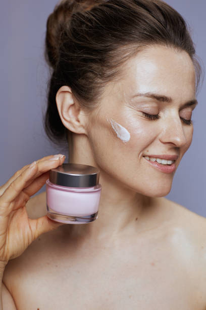 istock happy woman with cosmetic cream jar 1458722743