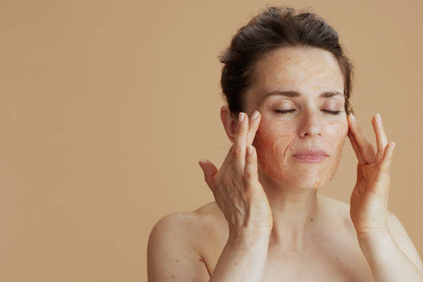 istock young woman with face scrub isolated on beige 1458722815