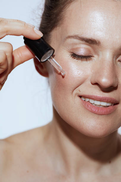 istock Closeup on happy woman with cosmetic elixir 1458722827