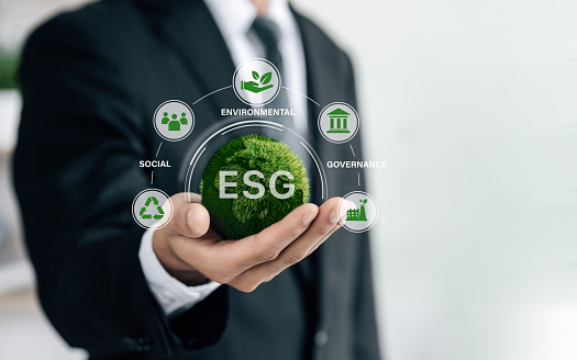business hand of human holding green earth ESG icon for  environmental, social and governance for sustainable organizational development. account the environment, society and corporate governance