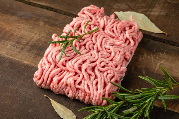 istock Raw minced meat made in a meat grinder, wooden table. 1458723686