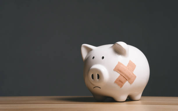 Broken piggy bank with band aid bandage or plaster in finance background concept for economic recession, depression or bankruptcy Broken piggy bank with band aid bandage or plaster in finance background concept for economic recession, depression or bankruptcy bankruptcy stock pictures, royalty-free photos & images
