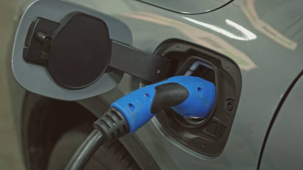 istock Hybrid Electric Car Socket with Plugged In Charger Cable 1458724854