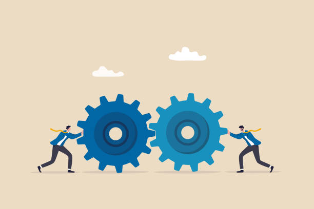 istock Teamwork and cooperation in a business setting, idea that working together can lead to success, collaboration or synergy concept, businessman push gear cogwheels together leading to success. 1458724879