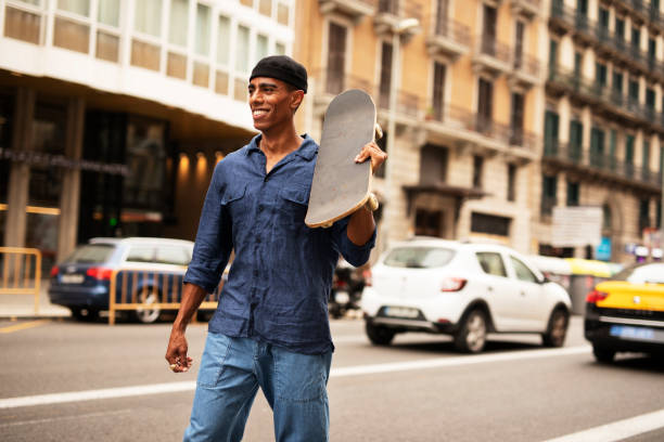 istock Young handsome man with a skateboard using the phone outdoors 1458725960