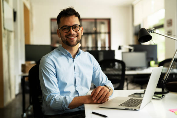 istock Handsome young man working on laptop 1458726188