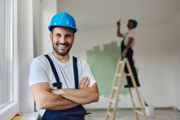 istock Happy worker with crossed arms during home renovation. 1458728147