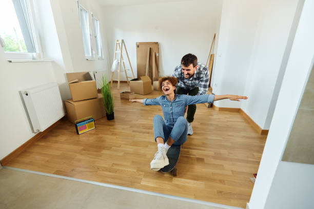 istock Cheerful couple having fun at their new apartment. 1458728201