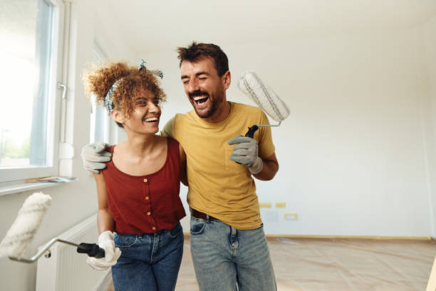 istock Cheerful couple having fun during home renovation process. 1458728284
