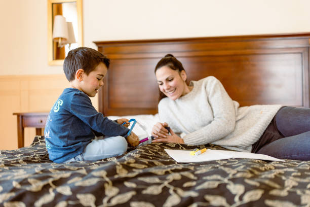 istock Mother and son having fun in bedroom 1458728869