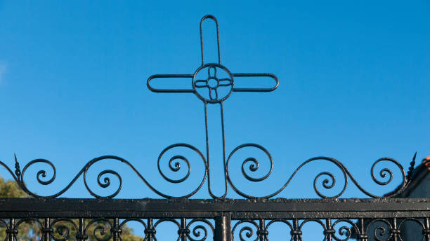 istock Iron forged cross on blue sky 1458728947