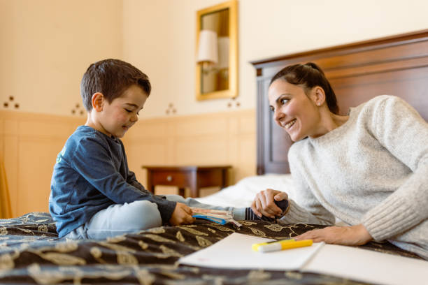 istock Mother and son having fun in bedroom 1458728998