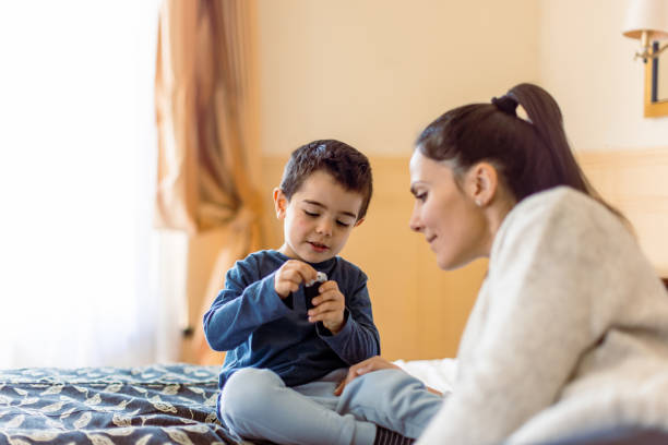 istock Mother and son having fun in bedroom 1458729153