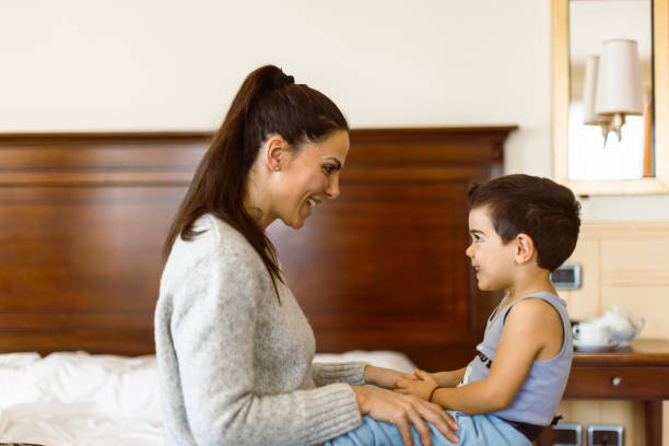istock Mother and son having fun in bedroom 1458729597