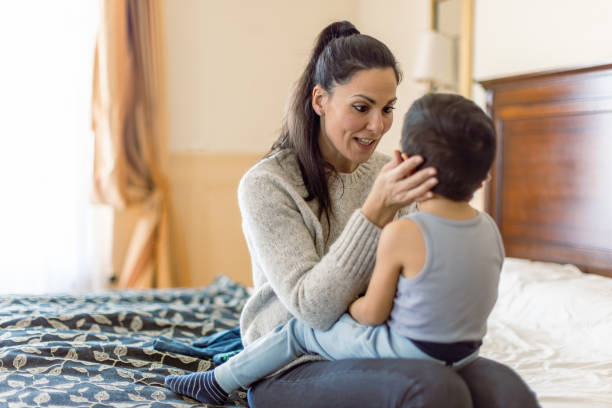 istock Mother and son having fun in bedroom 1458730163