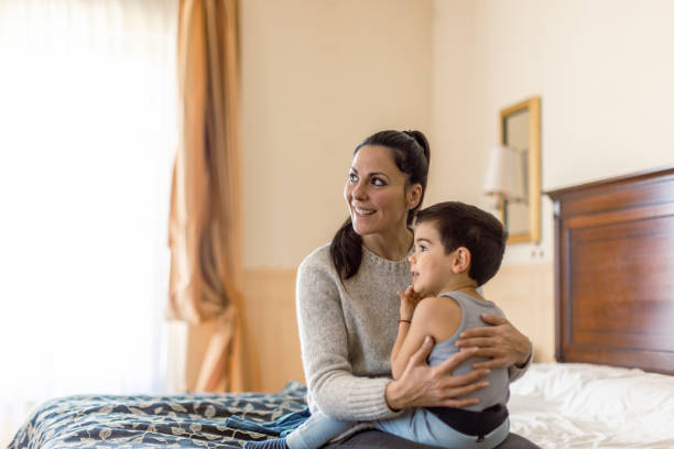 istock Mother and son having fun in bedroom 1458730165