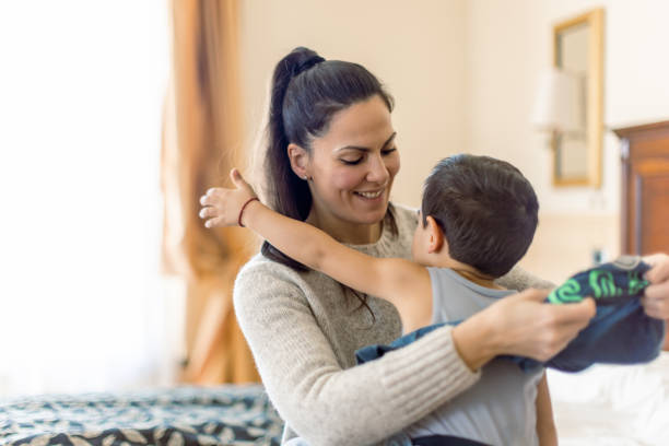 istock Mother dressing her little boy 1458730235