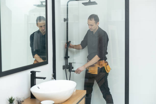 istock Plumber installing a shower cabin in bathroom 1458730760