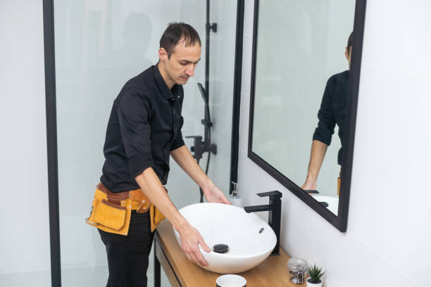 istock The worker installs the mirror in the bathroom 1458730786