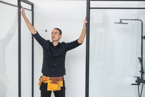 istock Plumber installing a shower cabin in bathroom 1458731827