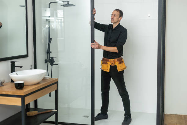 istock Young plumber fixing shower cabin. 1458731839