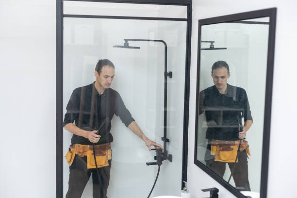 istock Young plumber fixing shower cabin. 1458731870