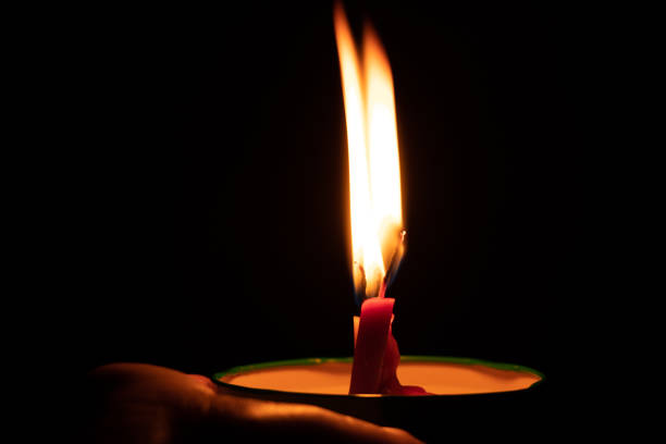 istock candle fire in the dark, burning candle flame 1458735763