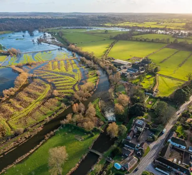 Aerial photo from a drone of The River Avon captured in January 2023. The river has burst its banks in this image and is causing flooding. This was captured from Fordingbridge looking south.