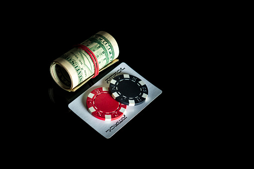 Joker card and dollars and chips. Winning combination at a poker club or casino
