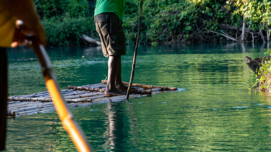Punting down a river on a bamboo raft