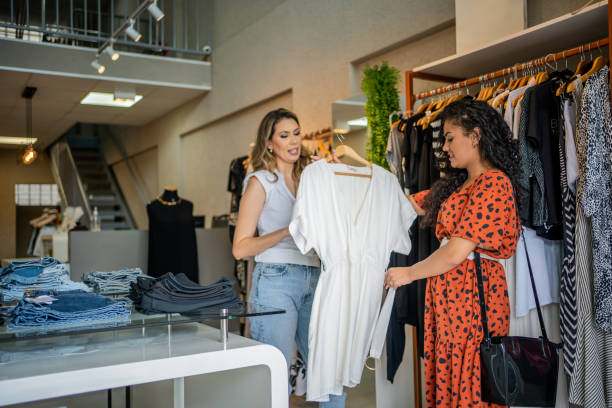 istock Clothing saleswoman assisting a customer 1458745734
