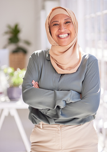 Success, leadership and portrait of Muslim woman in office with crossed arms, smile and confidence. Empowerment, professional and happy female worker standing in workspace for marketing startup