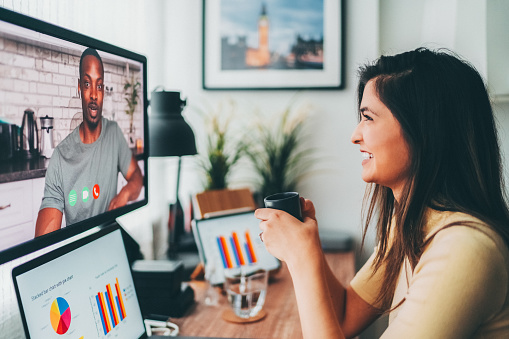 Young woman working at home is talking with boyfriend on video call