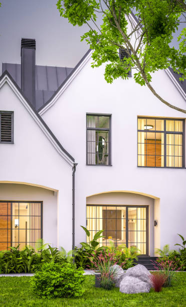 istock 3d rendering of white and black modern Tudor house in evening 1458749229